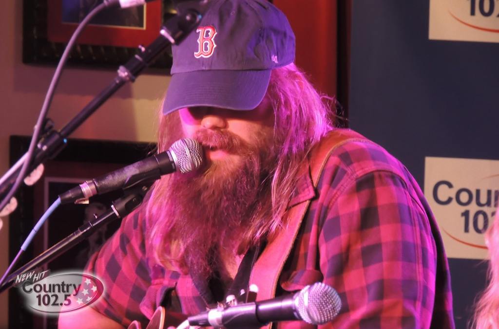 Chris Stapleton in a Red Sox baseball cap singing acoustically at County 102.5's benefit concert at the Hard Rock Cafe in Boston