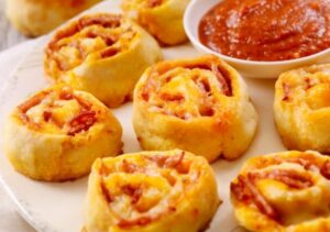 plate of pepperoni rolls with side of sauce