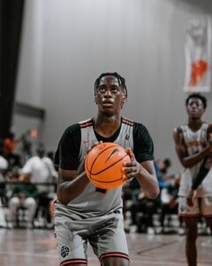 AJ Dybantsa holding a basketball, preparing to take a free throw shot.