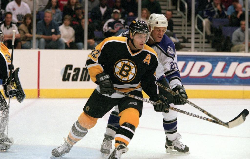 13 Oct 2000: Don Sweeney #32 of the Boston Bruins goes up against Craig Johnson #23 of the Los Angeles Kings during the game at the Staples Center in Los Angeles, California. The Kings defeated the Bruins 5-0.Mandatory Credit: Kellie Landis /Allsport