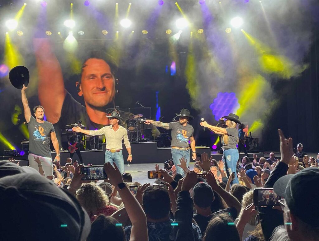 Tim McGraw taking a bow with Russell Dickerson and opening acts