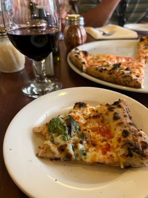 Plates of pizza and wine on Botson North End Food Tour