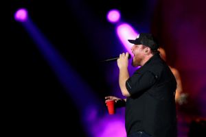 luke combs with cup in his hand