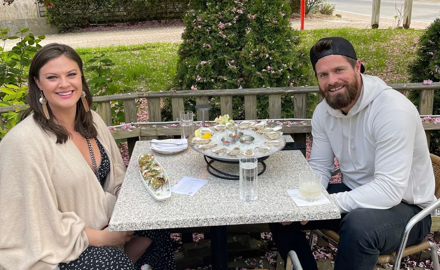 Ayla Brown and Rob Bellamy at a table eating oysters
