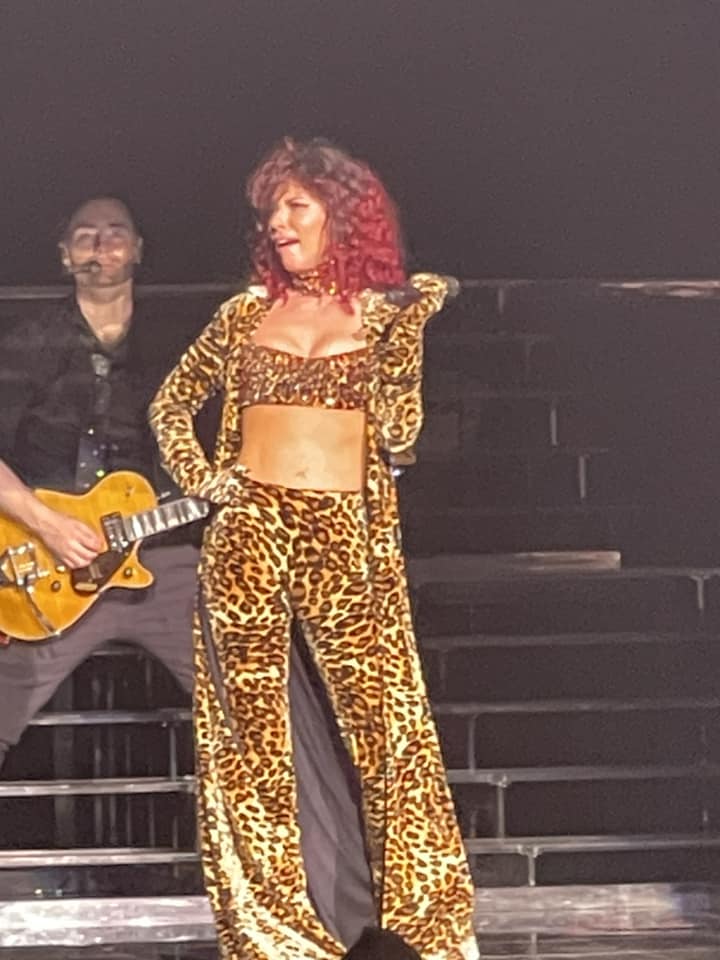 Shania Twain at Xfnity Center July of 2023 in leopard pring midriff top and pants with red wig 