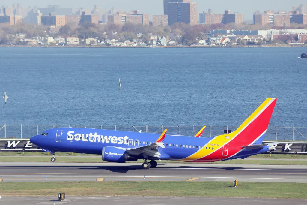 southwest flight on the ground with city in the background
