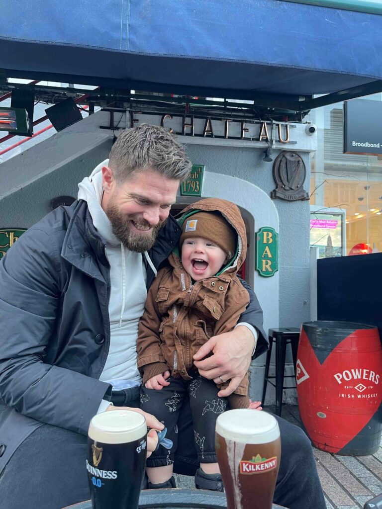 Rob Bellamy and son, Barrett in front of an Irish bar with two pints