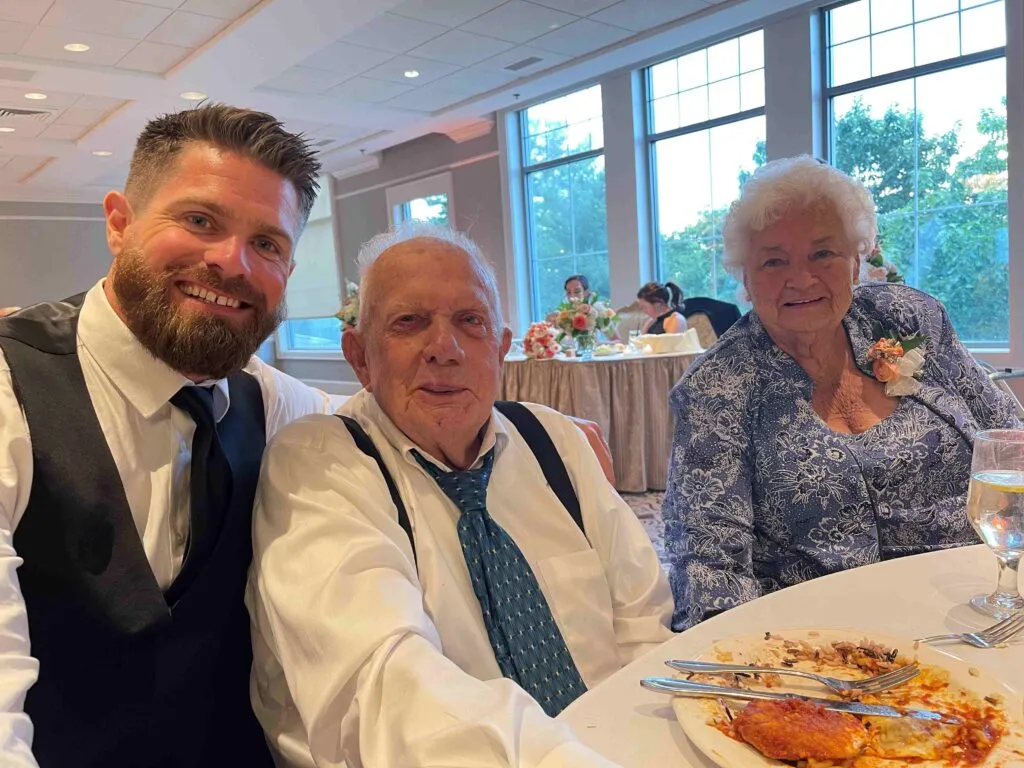 Rob Bellamy with his grandfather and grandmother at a wedding