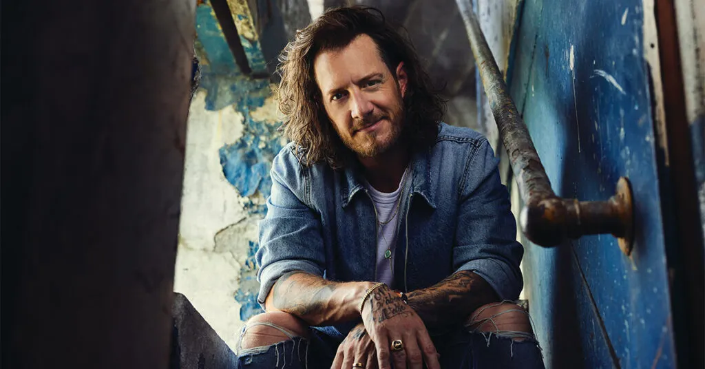 Tyler Hubbard sitting on some stairs