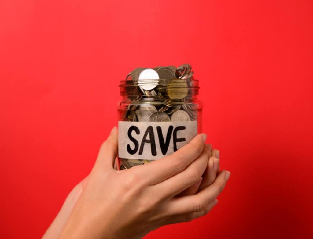 Hand holding coins in glass jar, Financial business investment, Growing money, People saving money, Money for future, Money saving concept